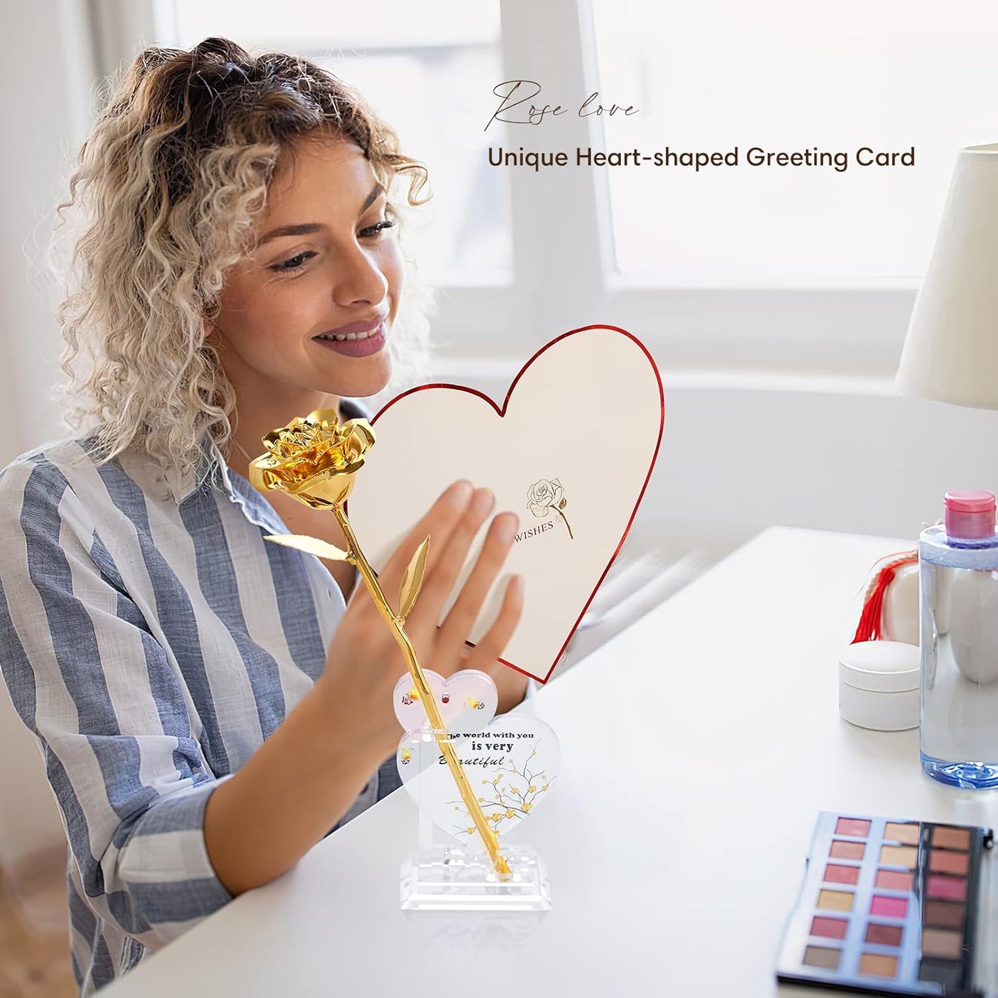 Woman holding a heart-shaped greeting card with a gold pen, surrounded by makeup items on a table.
